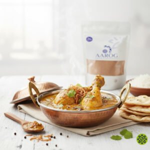 Home Aarog Perfect Authentic Quorma Masala recipe mix pouch with a bowl of finished Quorma curry.
