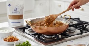 Aarog Perfect Authentic Quorma Masala recipe mix pouch with a bowl of finished Quorma curry.